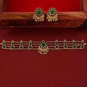 Traditional emerald kundan choker with crescent pendant, pearl hangings, antique gold finish, and matching earrings.