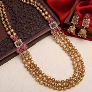 South Indian Sita necklace with three layers of matte gold beads, pearls, intricate beads, ruby flower motifs, square pendants, and matching earrings.