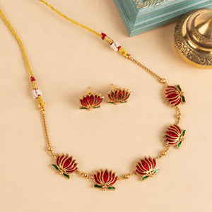 Padmavathi Blossom choker set with ruby enamel lotus motif, emerald green leaves, and gold link chain featuring matching stud earrings.