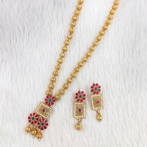 South Indian Sita necklace with ruby and white stones, square blossom pendants, red petal floral motifs, matte gold bead chain, and matching rectangular drop earrings.