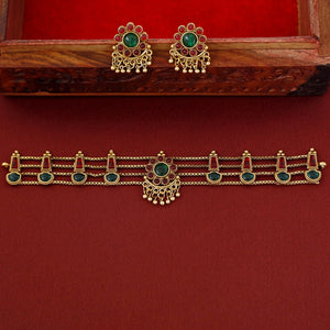 Traditional ruby emerald kundan choker with crescent pendant, pearl hangings, antique gold finish, and matching earrings.