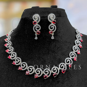 Ruby Red Diamond Cut Spiral Necklace Set with droplet stones and matching earrings – elegant swirl design – Ornatales