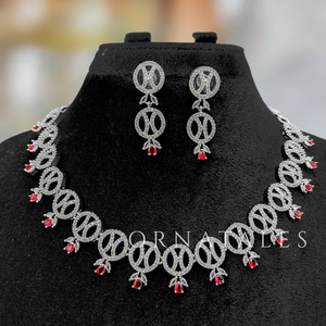 Ruby Red Diamond Cut Necklace Set with interlinked round loops, droplet stones, and matching earrings – festive & wedding jewellery – Ornatales