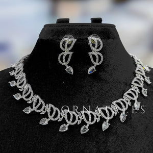 Crystal White Diamond Cut Necklace Set with wave-like looping structure and droplet stones – matching earrings – Ornatales