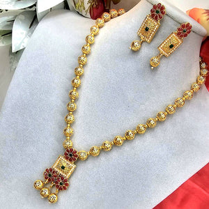 South Indian Sita necklace with ruby and white stones, square blossom pendants, red petal floral motifs, matte gold bead chain, and matching rectangular drop earrings.