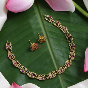 Rajnandini Lotus Garland Necklace Set featuring alternating lotus motifs with lotus pink kundan stones, antique gold finish, and matching earrings.