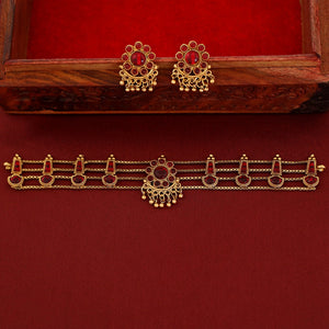 Traditional ruby kundan choker with crescent pendant, pearl drops, antique gold finish, and matching earrings.