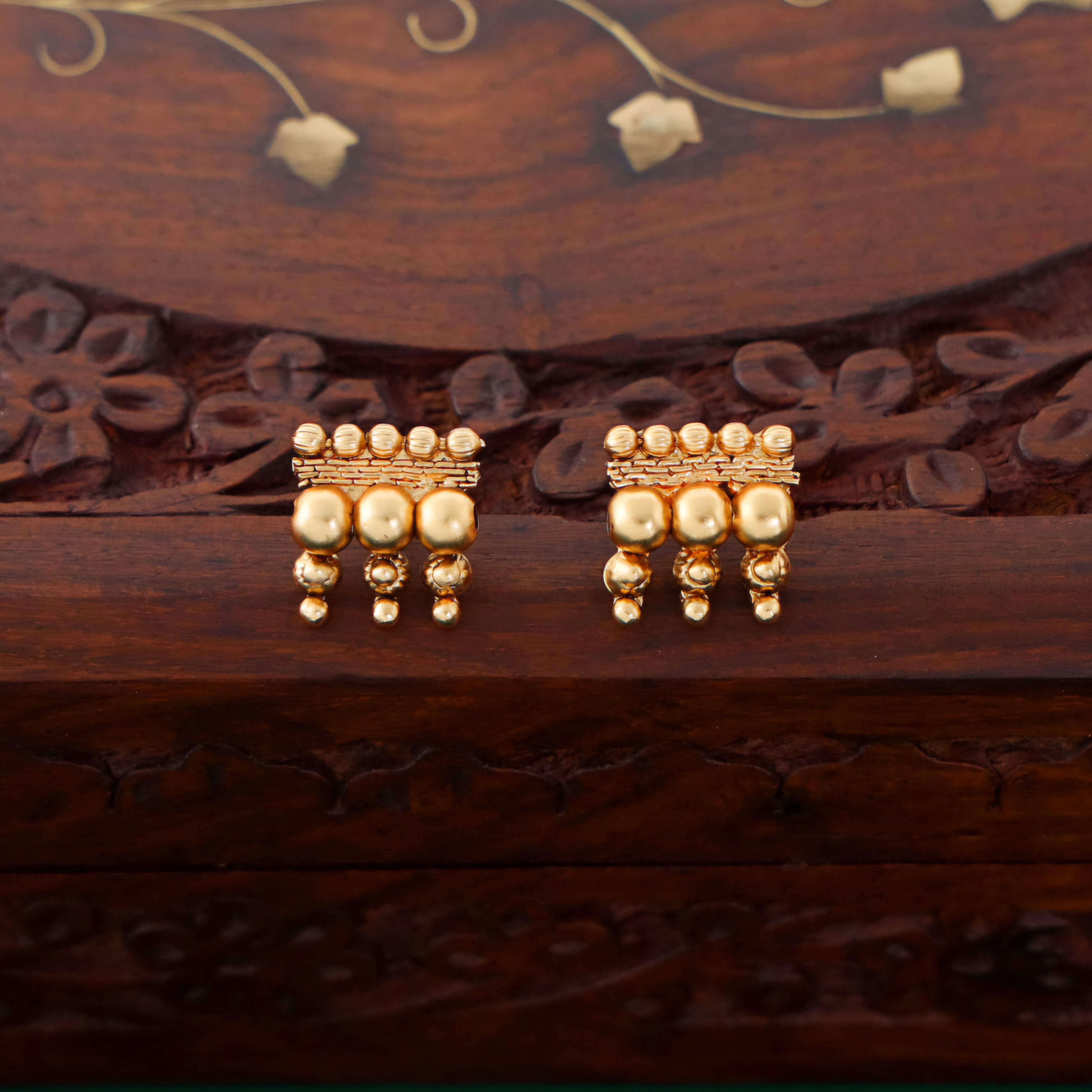 Antique gold beaded choker necklace with triple-layer gold ball beads, temple-inspired detailing, and matching earrings.
