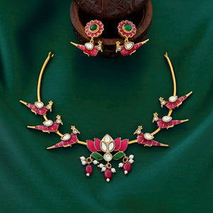Temple-style ruby necklace with peacock and lotus motifs, pearl accents, and antique gold finish.