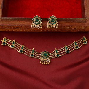 Traditional emerald kundan choker with crescent pendant, pearl hangings, antique gold finish, and matching earrings.