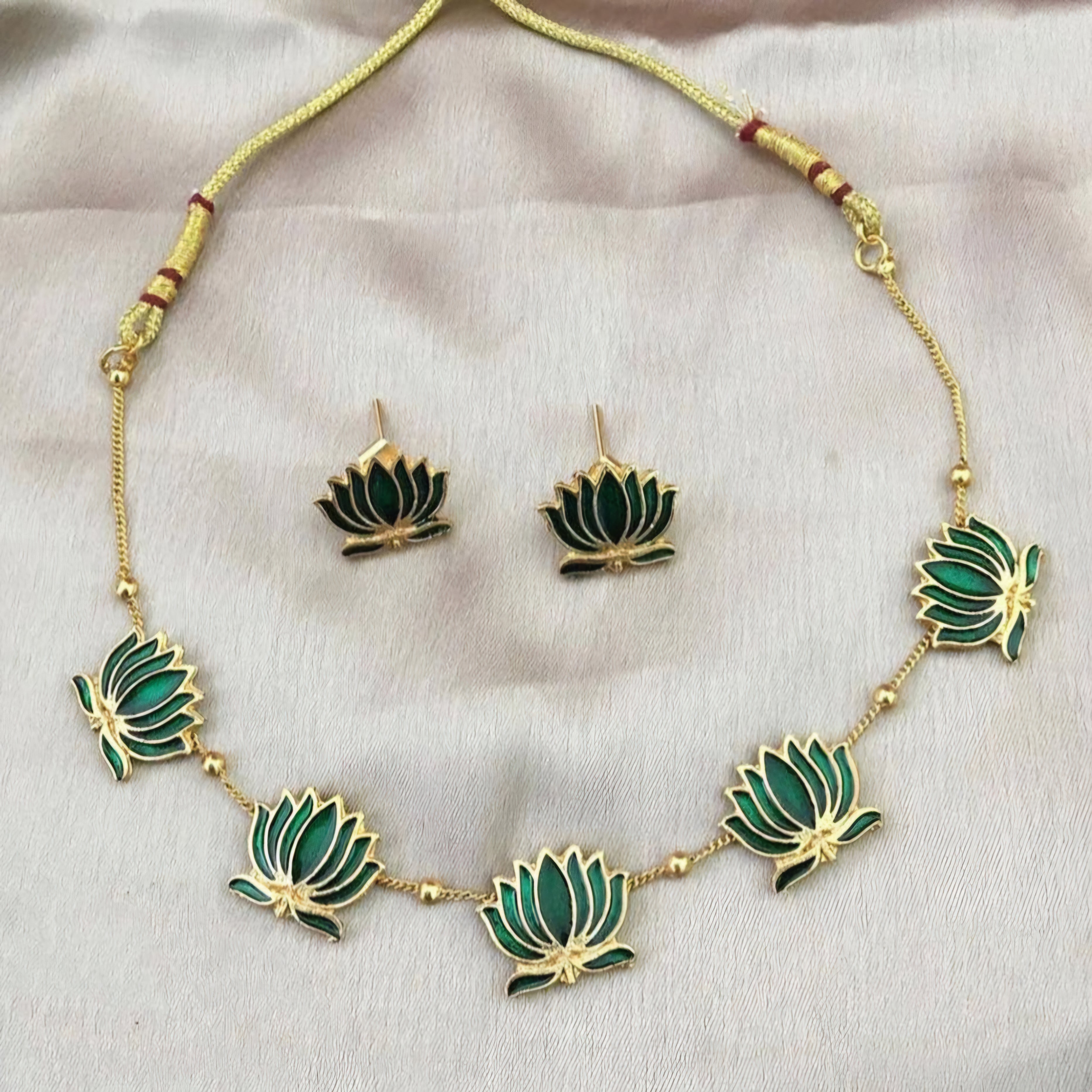 Padmavathi Blossom choker set with emerald green enamel lotus motif, gold link chain, and matching stud earrings in a traditional temple design.