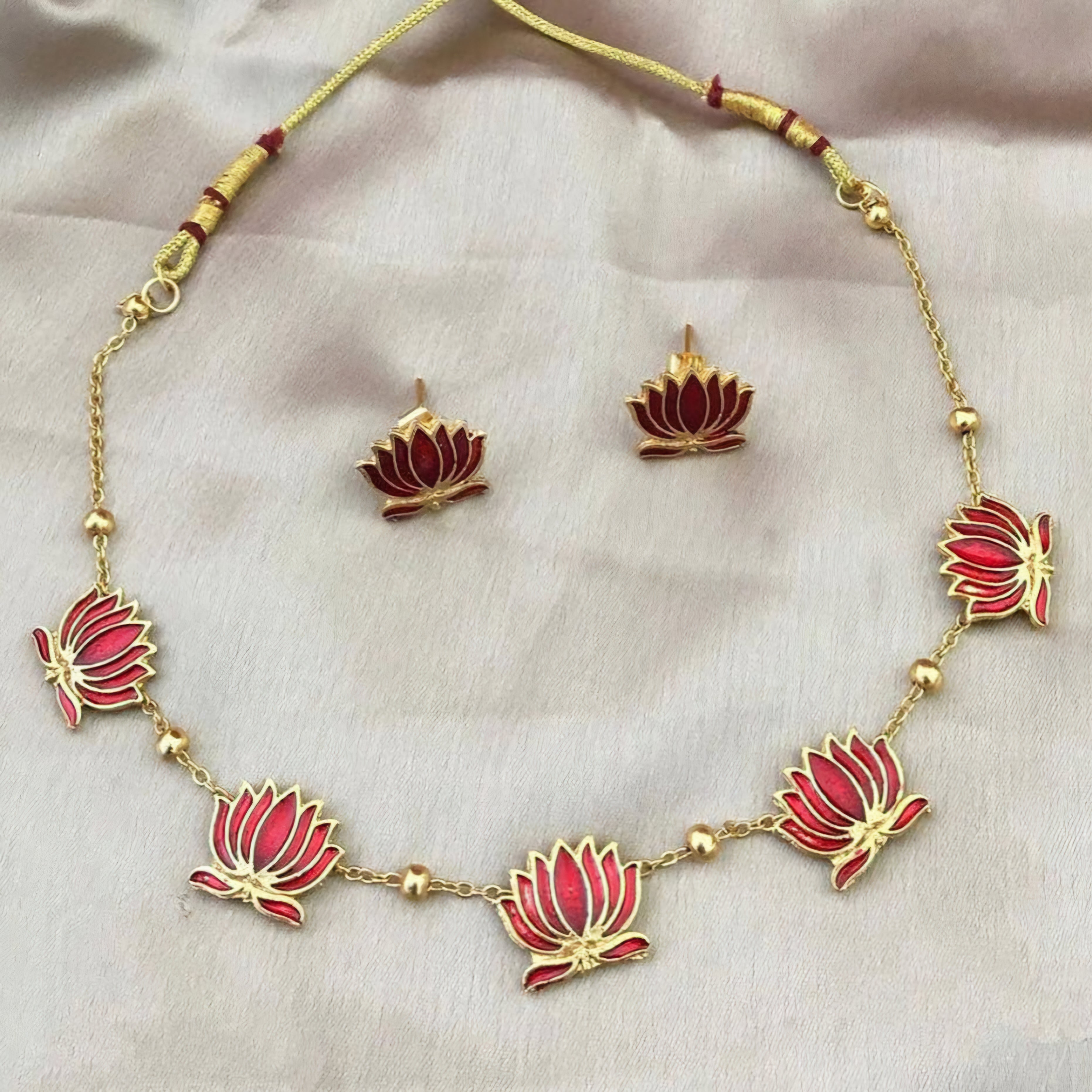 Padmavathi Blossom choker set with ruby red enamel lotus motif, gold link chain, and matching stud earrings in a regal temple design.