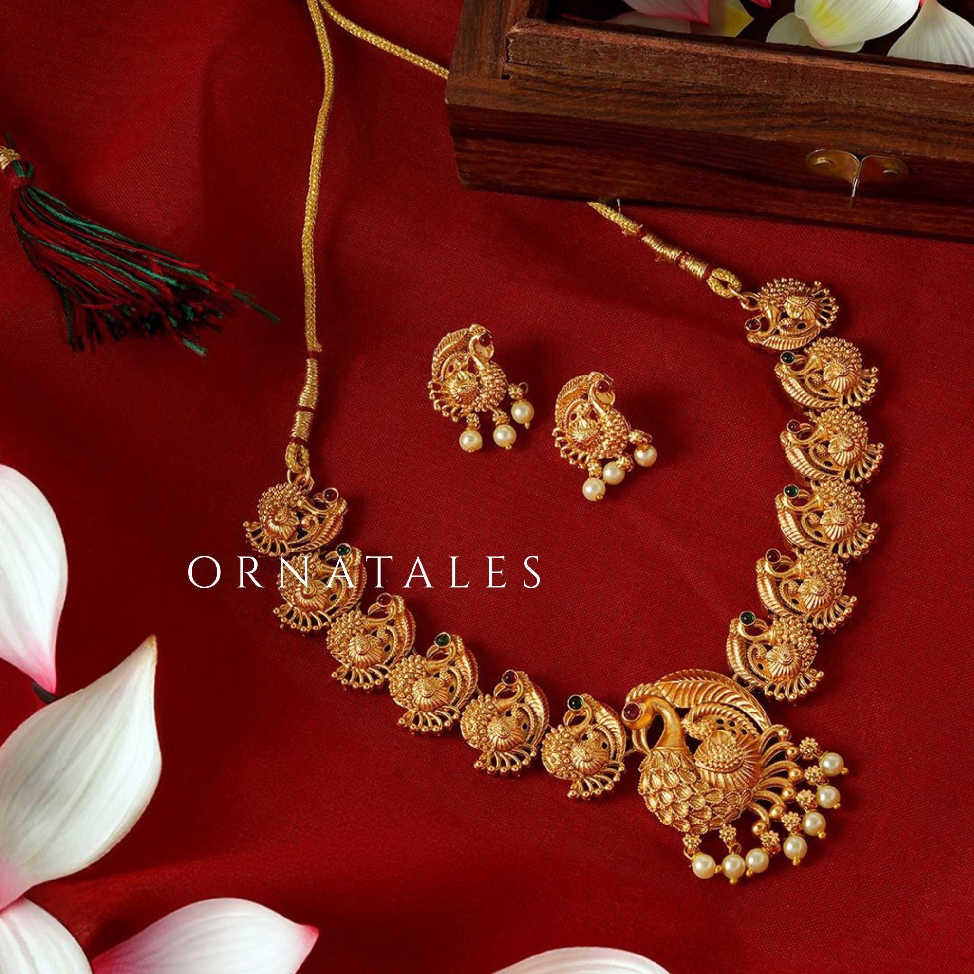Matte gold South Indian choker necklace with temple-style peacock motifs, pearl droplets, central peacock pendant, and matching earrings.