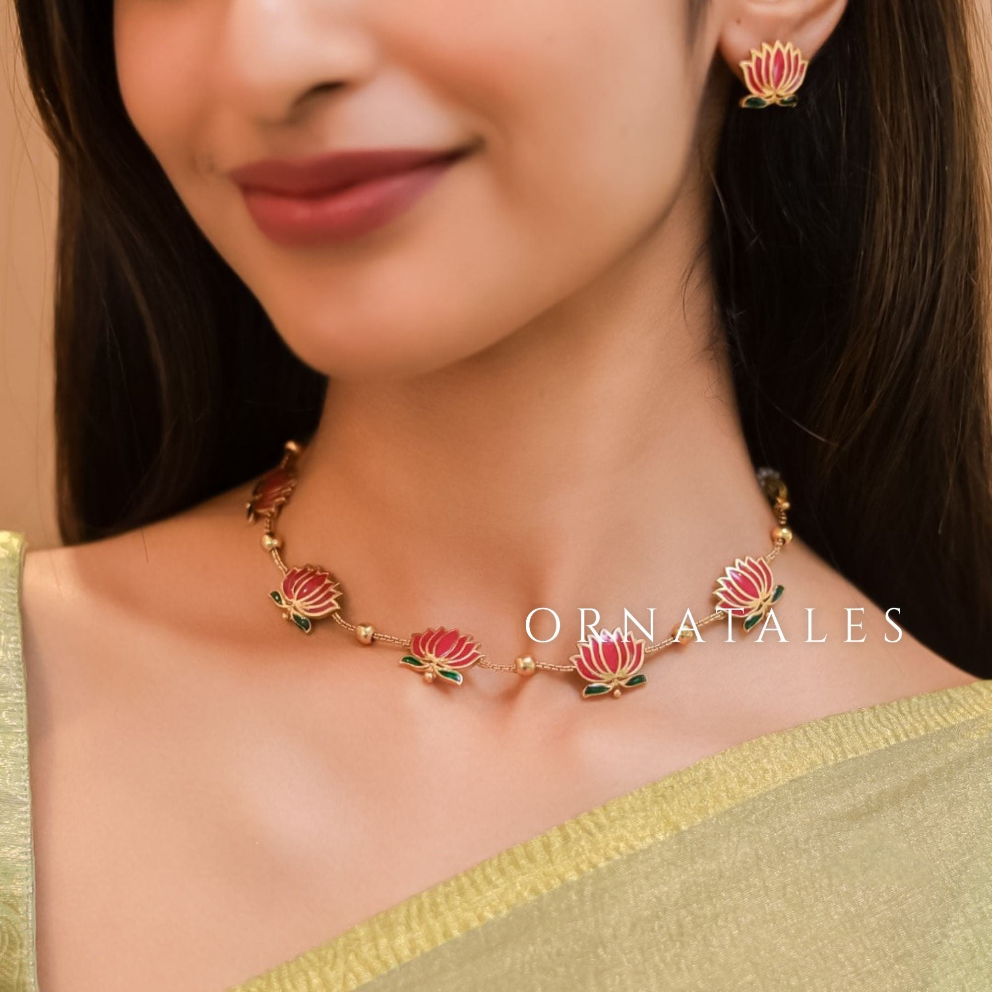Padmavathi Blossom choker set with ruby enamel lotus motif, emerald green leaves, and gold link chain featuring matching stud earrings.