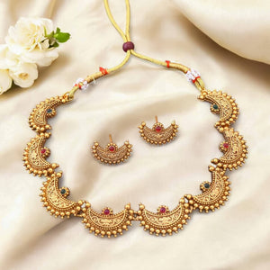 South Indian choker necklace with arched segments, red and green stones, micro-bead detailing, matte gold finish, and matching half-arch earrings.
