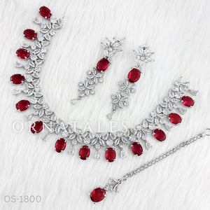 Silver necklace with red gemstones on a white background
