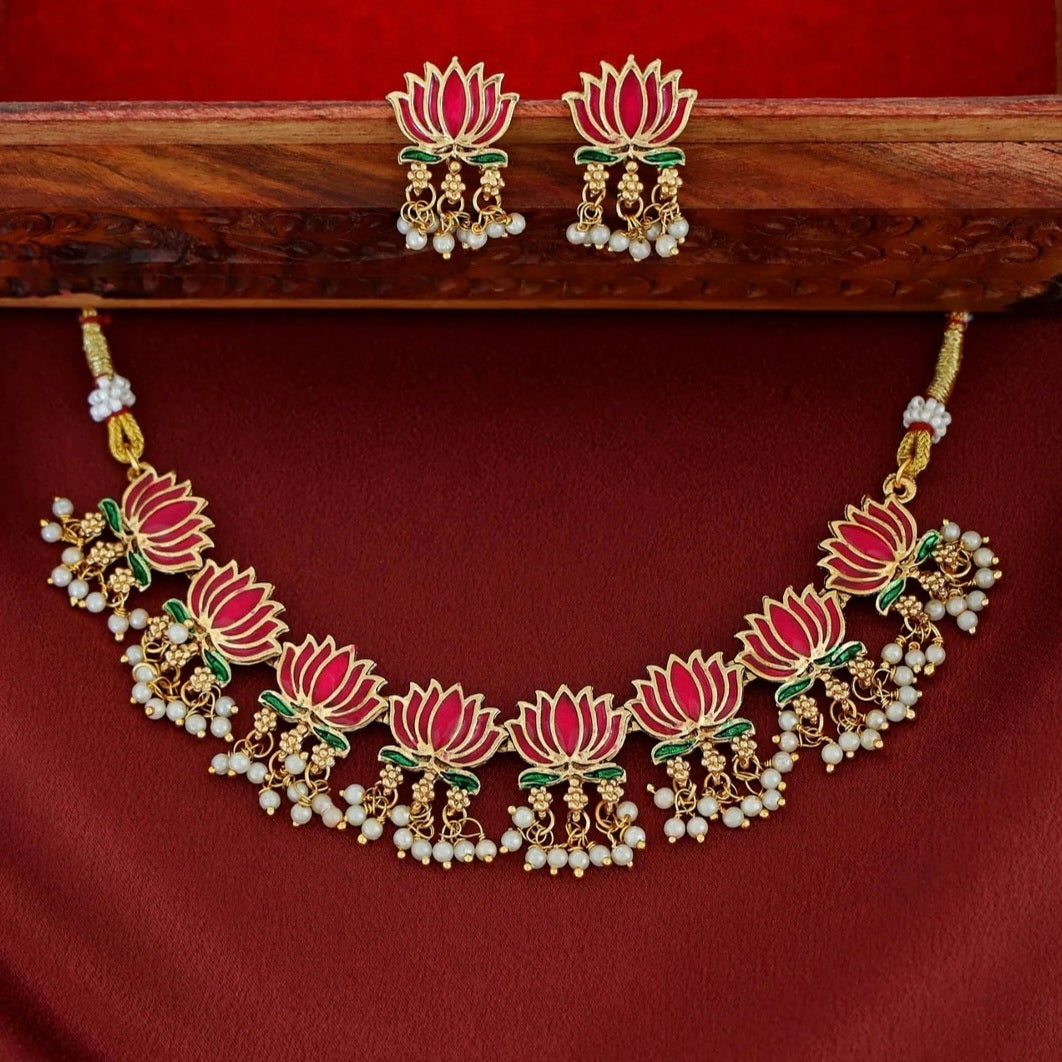 Kamalini Pearl Drop Choker Set with ruby-gold lotus motifs, hanging pearl clusters, and matching lotus drop earrings in a temple-inspired design.
